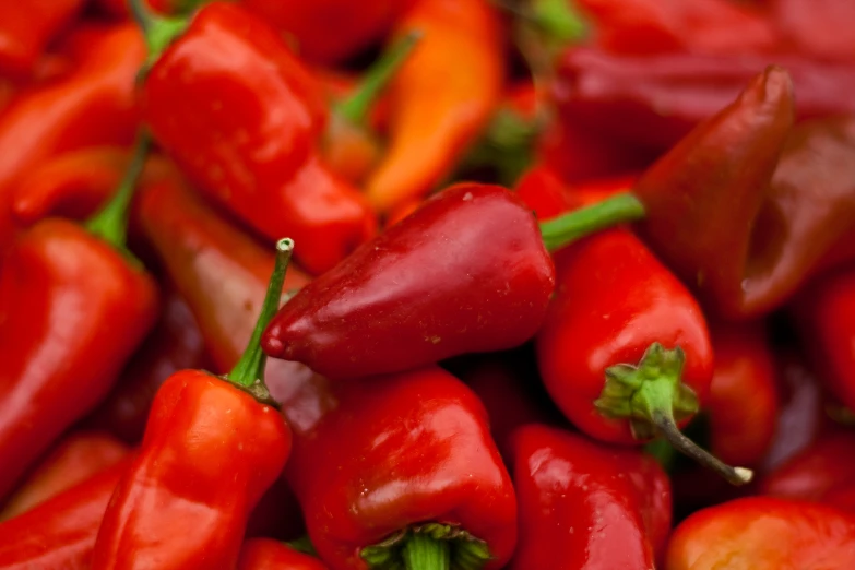 red peppers are stacked on top of each other