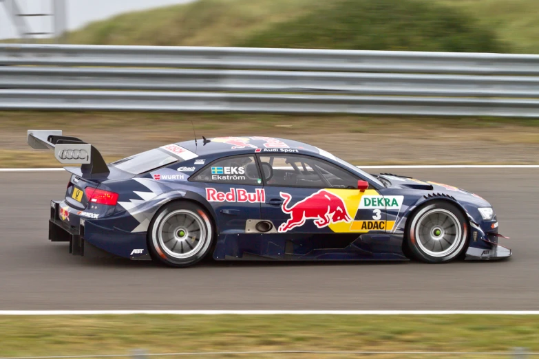 a car racing around an outside track during the day