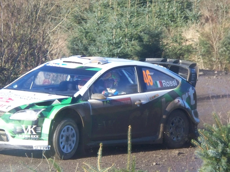 a car is driving on a dirt road