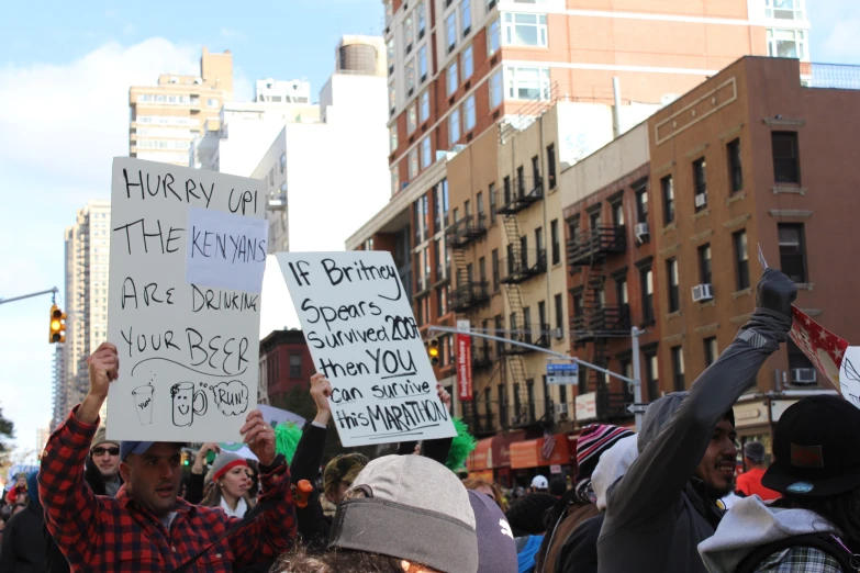 people are holding up signs while protesting on a city street