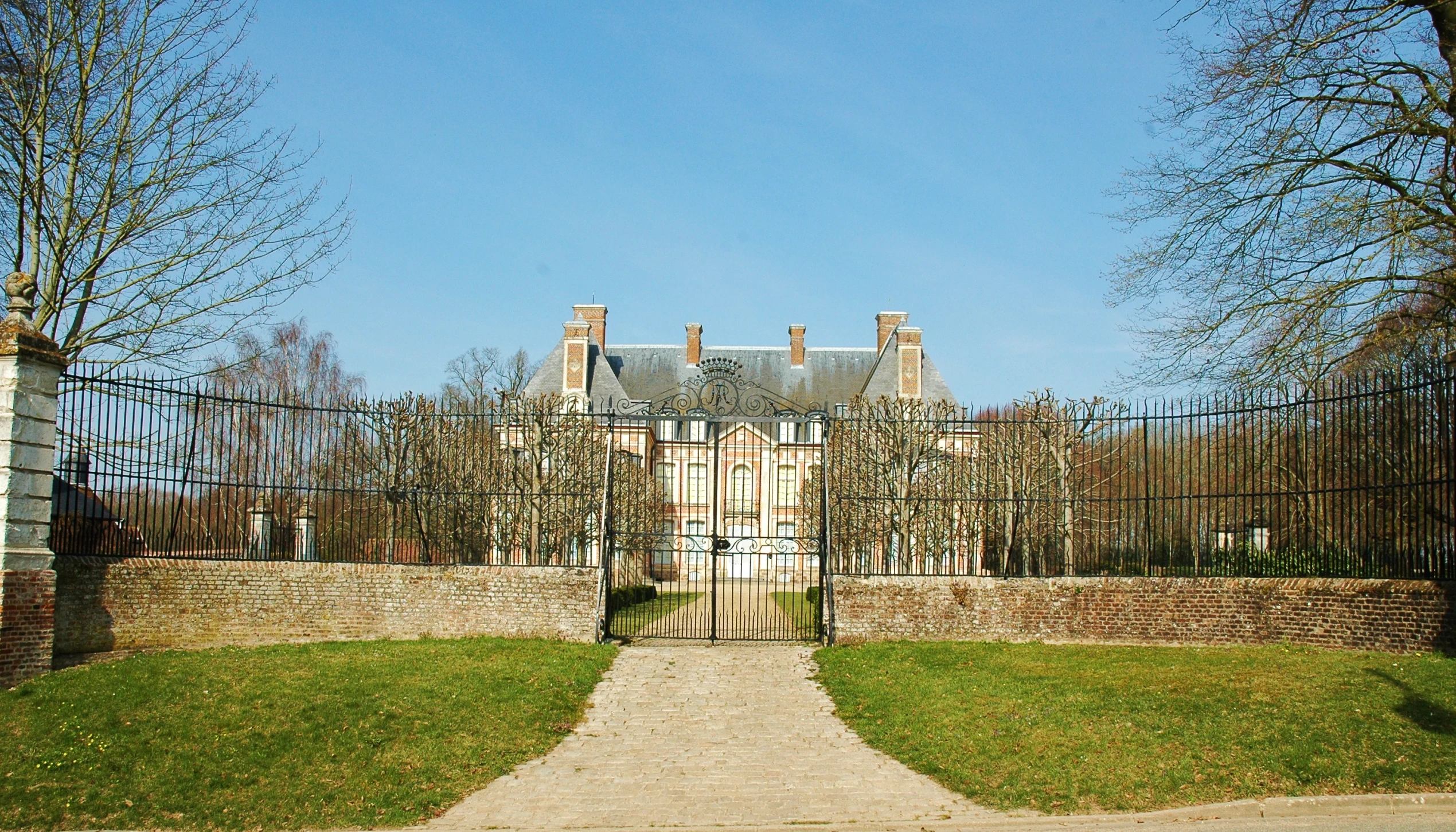 a long driveway leads to an expansive home