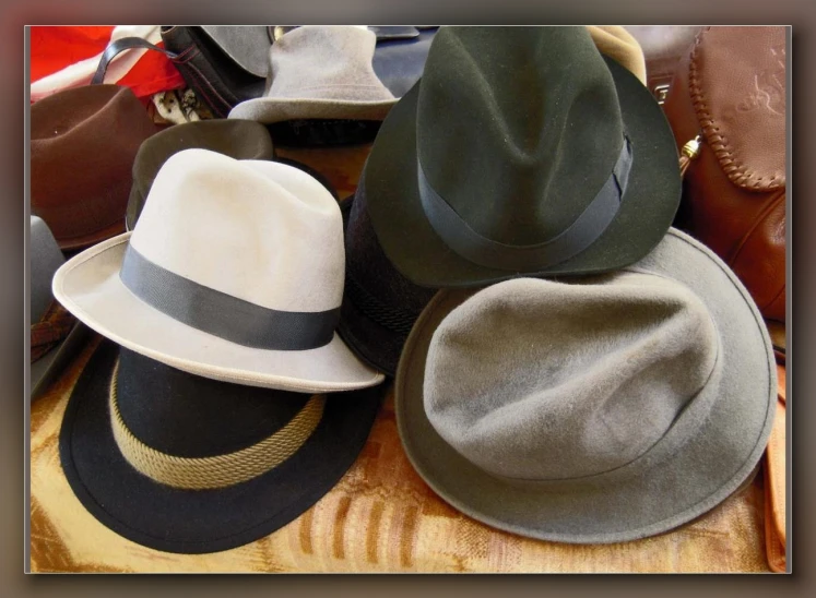 there is a variety of hats displayed on the table