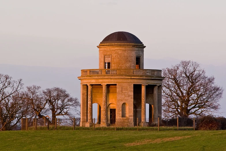 there is a tall round tower that looks like it has a balcony