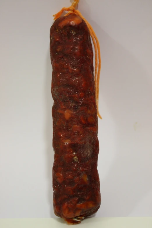 a partially eaten sausage on a white table