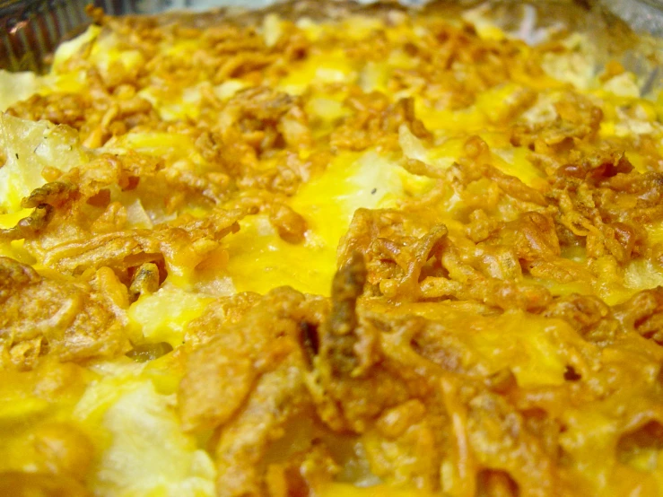 there is a cheesy dish in the pan with meat