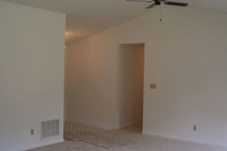 empty room in house, white walls and fan