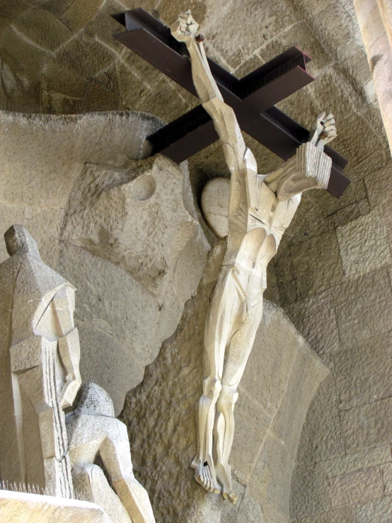 the statues hold up the cross above them