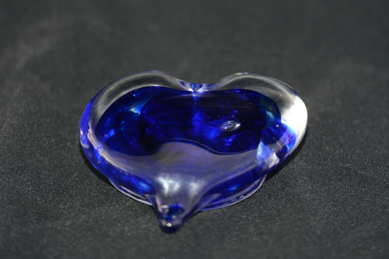 the decorative heart shaped brooche is made from glass