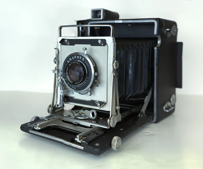 an old antique camera on a white surface