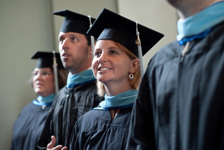 a group of graduates in caps and gowns in a row