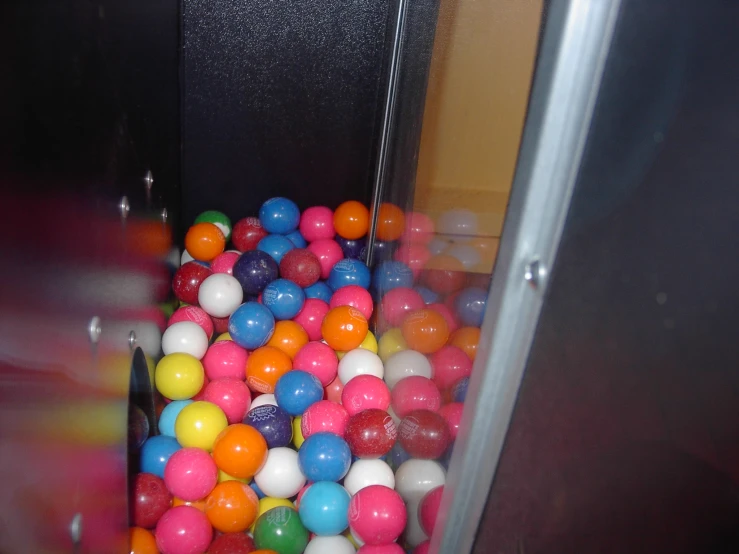 a bunch of colorful balls sitting in an open door