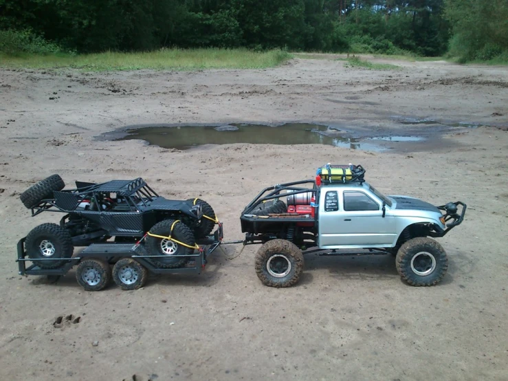 two jeeps are in the dirt with some tires