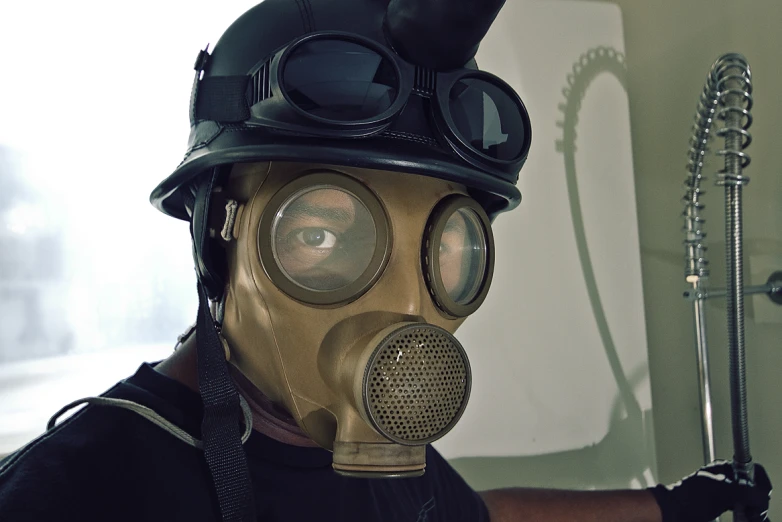 a man with a gas mask and a black helmet