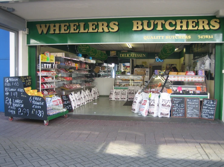 a store front with a bunch of signs in front of it