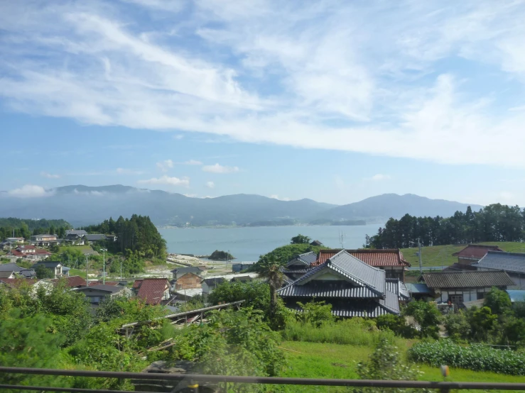 a town by the water with houses and water in the distance