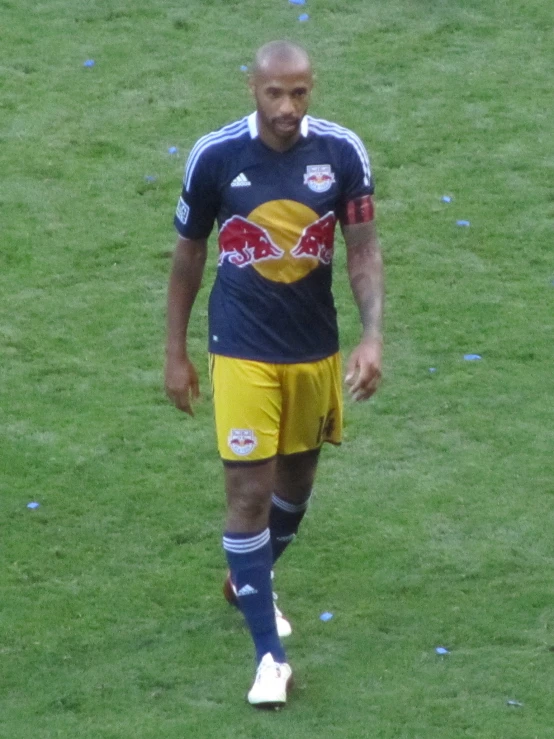 a soccer player is holding his ball in his hand