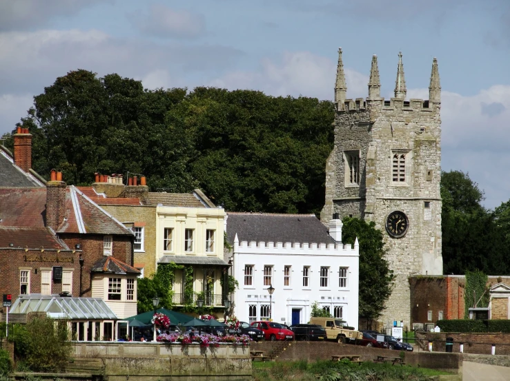 an old, run down stone castle sits beside the town