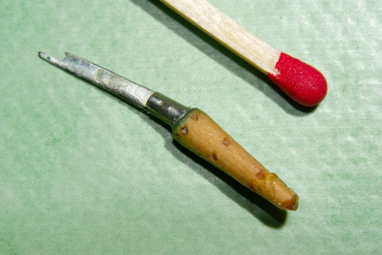 a close up of two different tooth brushes and a spoon