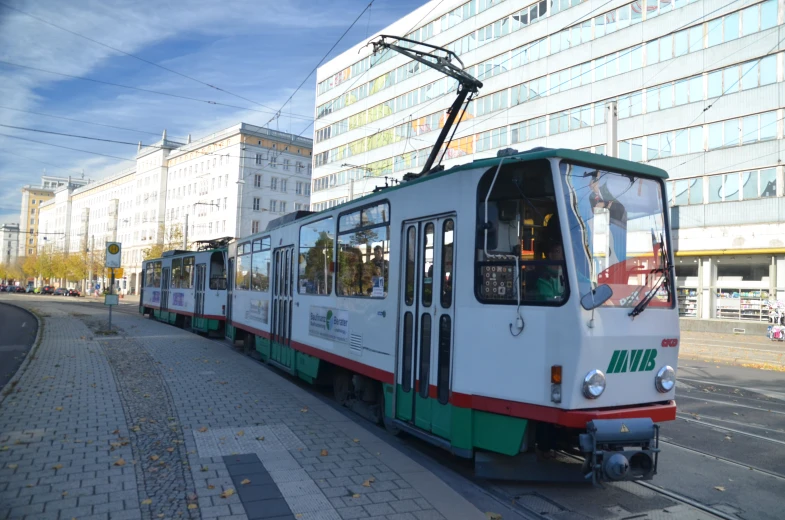 a trolley car on a city street in the middle of the day