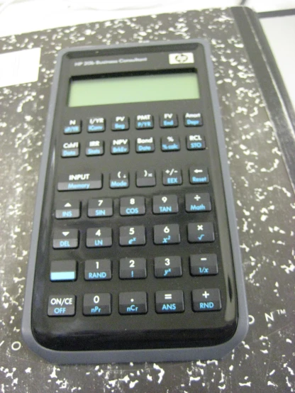 a calculator showing one hand on top of it