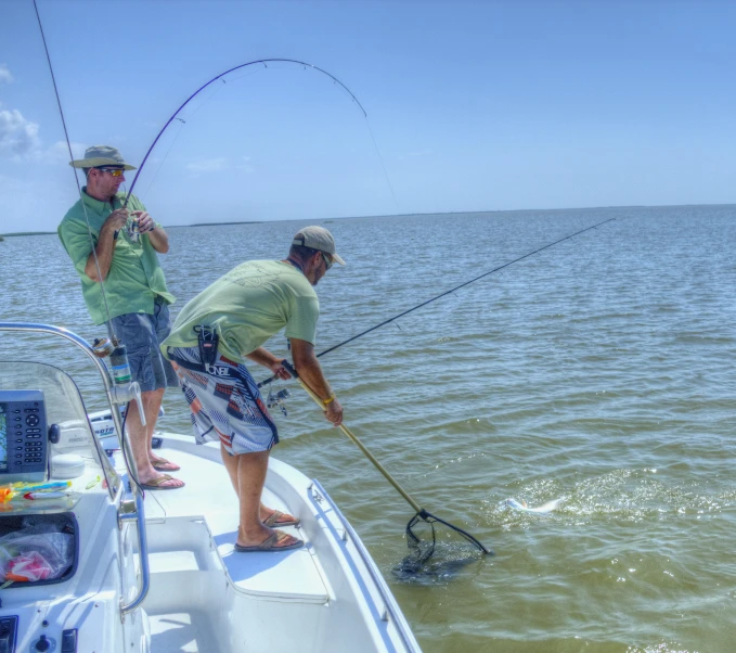 two men on a boat, with a fishing rod