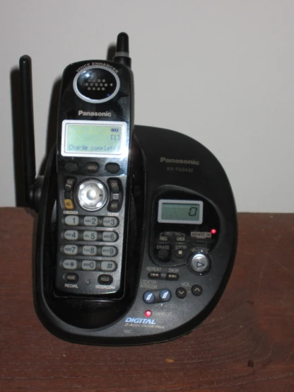 a black nokia cell phone in a holder on top of a desk