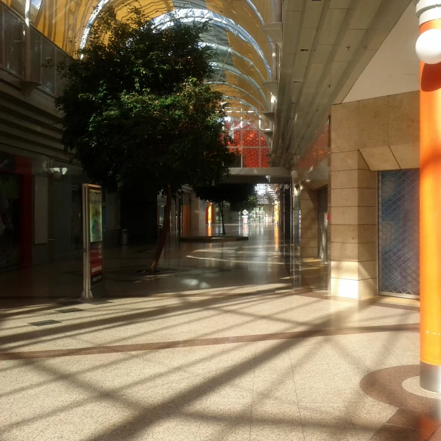 an empty walkway in the middle of an office building