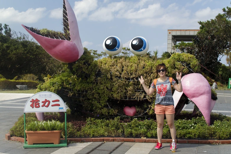 there is a girl posing in front of some sculptures