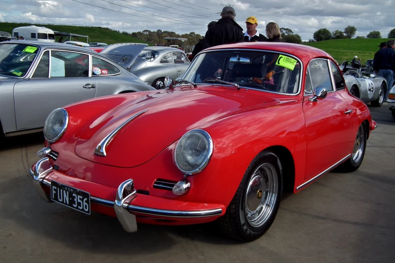 a red car is parked on the side of a road