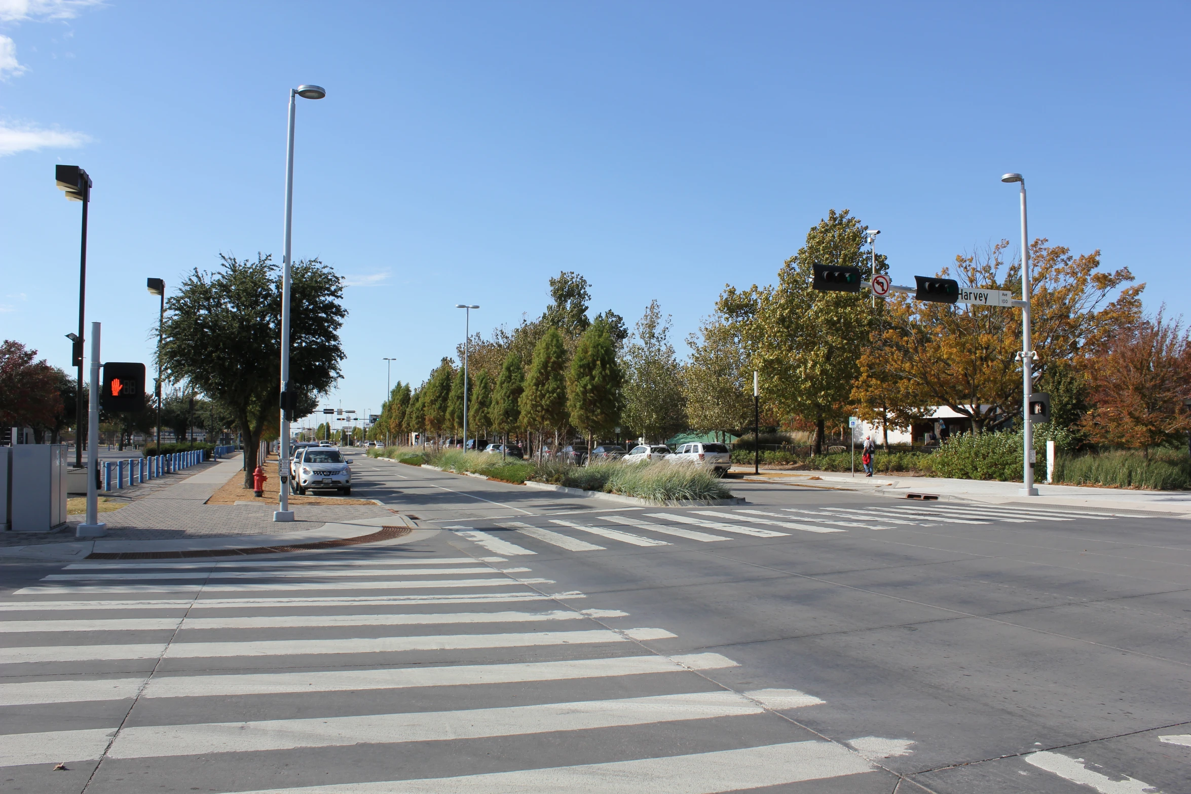 an empty street with a couple of cars at the intersection