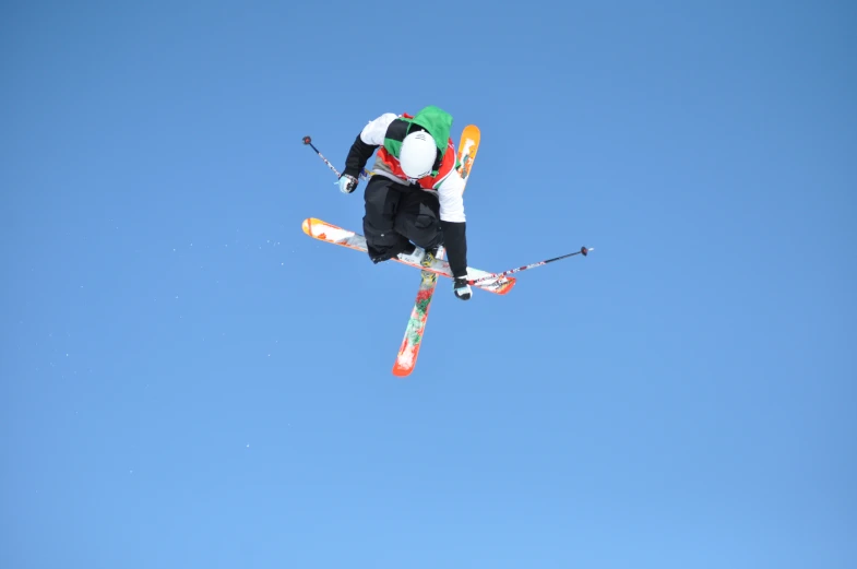 a person jumping in the air wearing skis
