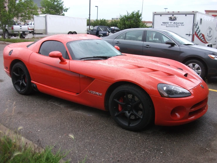 a red sports car is parked on the street
