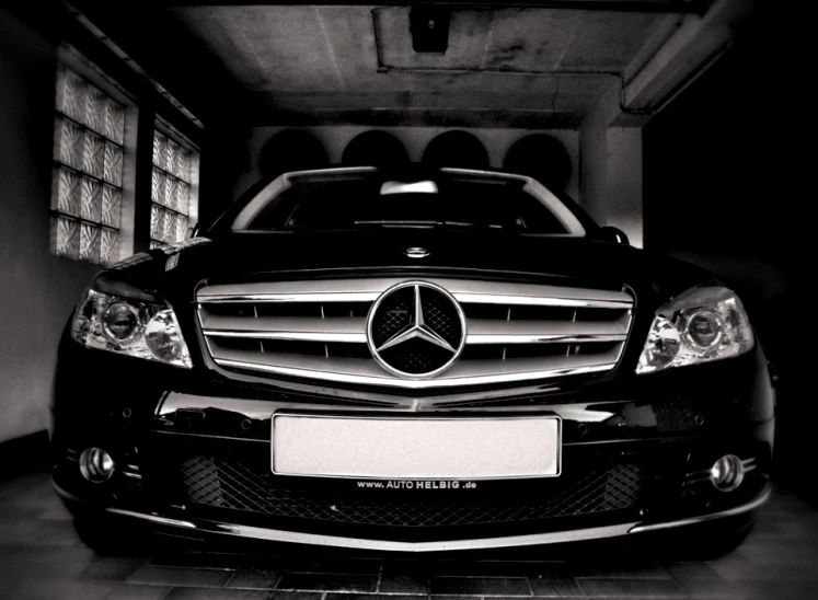 a mercedes benz coupe in a black and white po