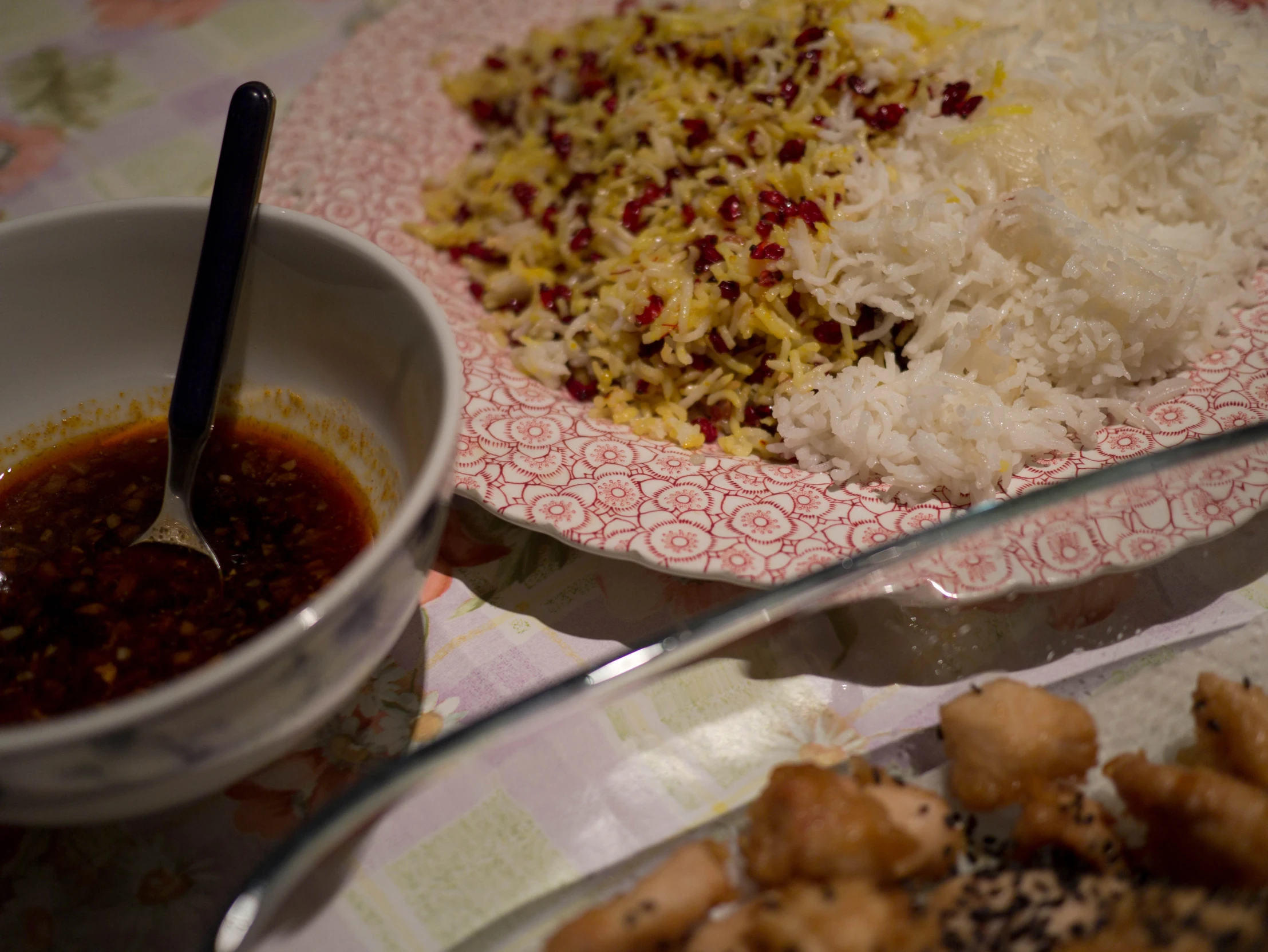 rice on a plate and a bowl of dipping sauce