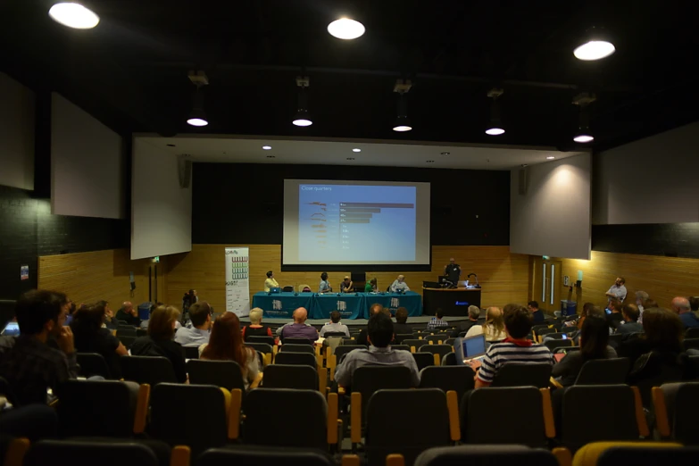 a stage in the middle of a building with people sitting at tables