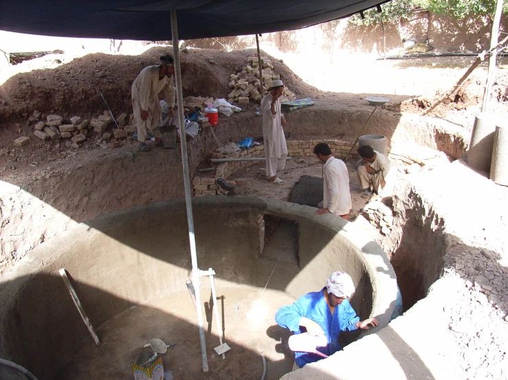 a group of people standing around in a concrete pit