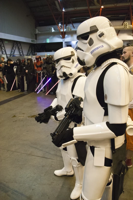 people dressed in stormtroopers standing around