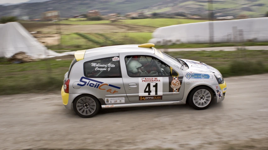 a small white car with an advertit on the side