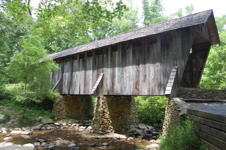 an old, wooden covered bridge in the woods