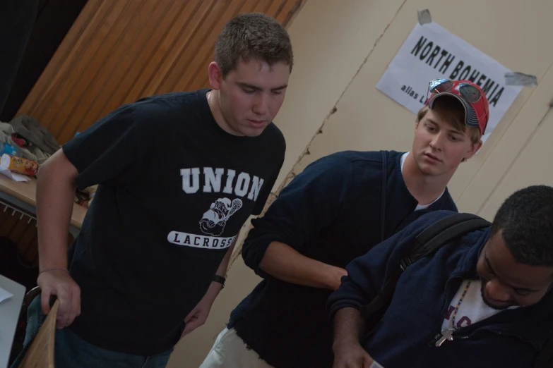 three boys are standing together in front of a sign that reads union