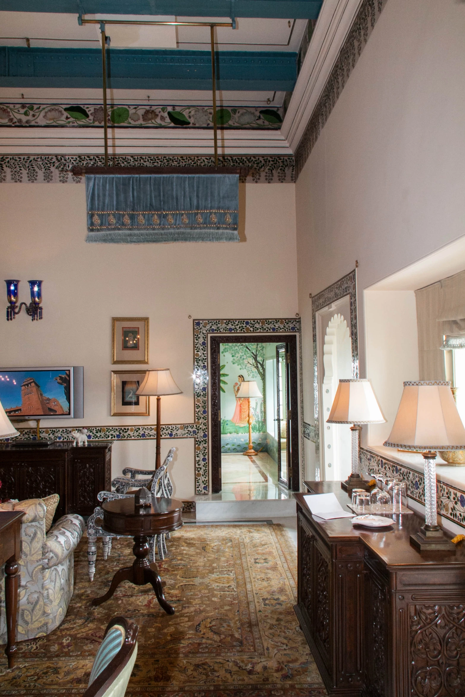 an ornate living room with lamps and chandeliers