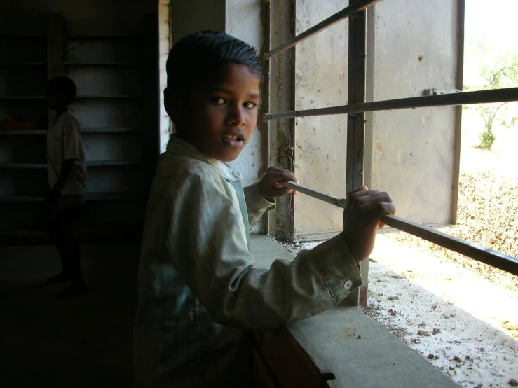 a young child working on window sill outside