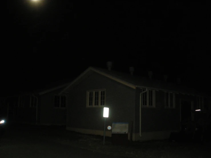 a house in the dark lit up by a light at night