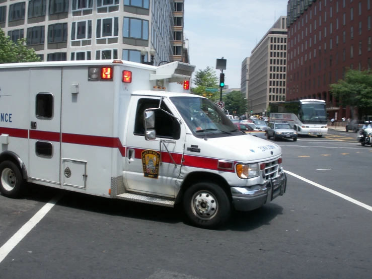 a ambulance parked near a parking lot on a busy day