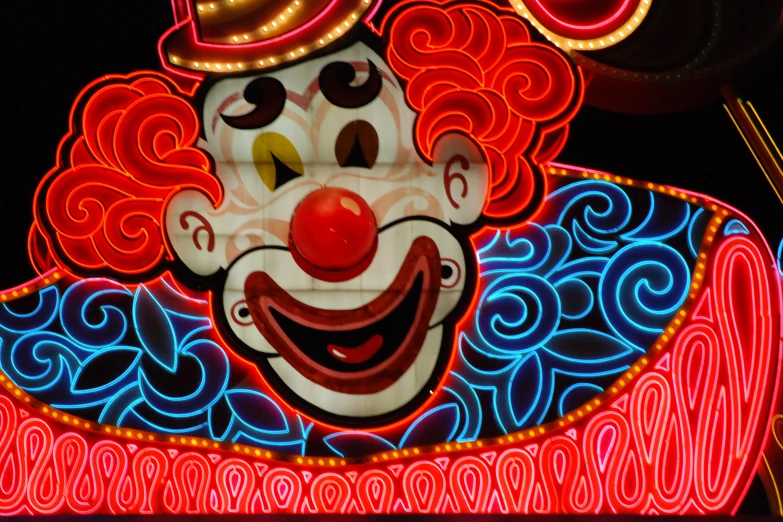 a lighted clown clown head in front of an audience
