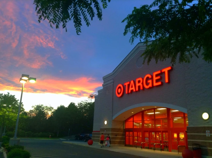 sunset behind target retail store with people walking by