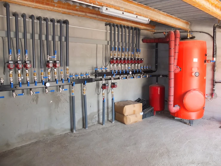 a garage containing two  water pipes, water pump and electrical wires