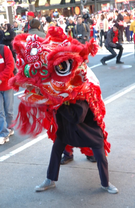 a man wearing a dragon mask and pointing to it