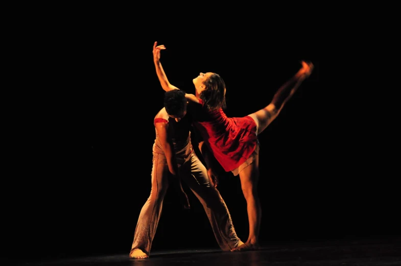 two dancers on a black stage