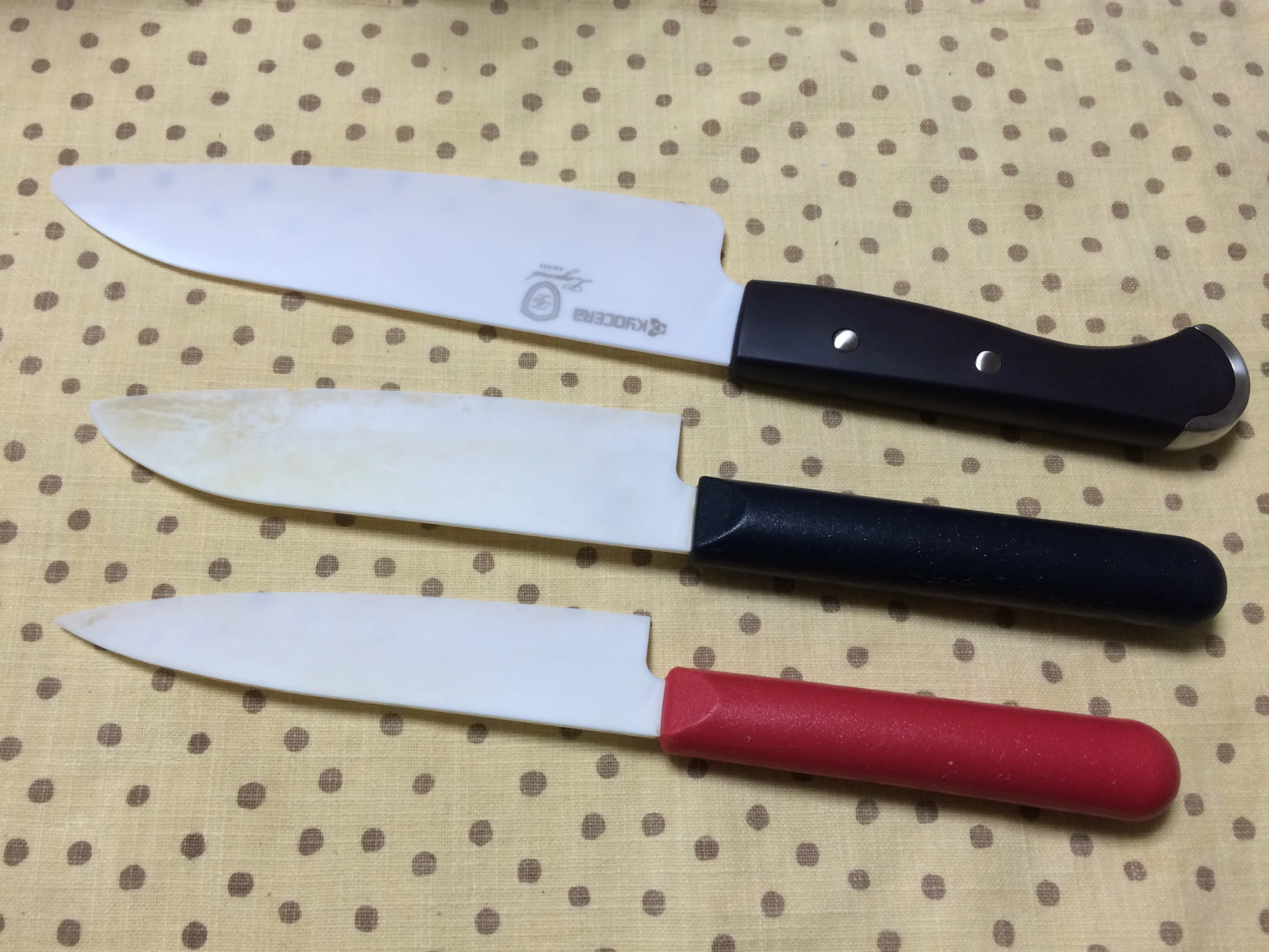 three knives that are laying next to each other